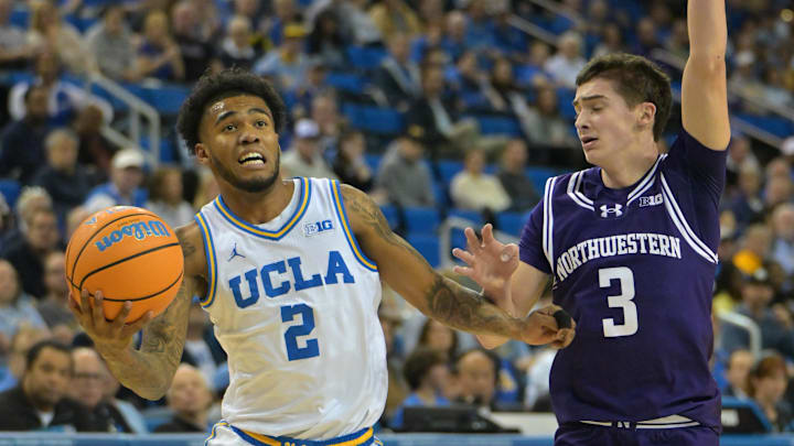 Jan 24, 2026; Los Angeles, California, USA;  UCLA Bruins guard Donovan Dent (2) is defended by Northwestern Wildcats guard Jake West (3) in the first half at Pauley Pavilion presented by Wescom Financial. Mandatory Credit: Jayne Kamin-Oncea-Imagn Images
