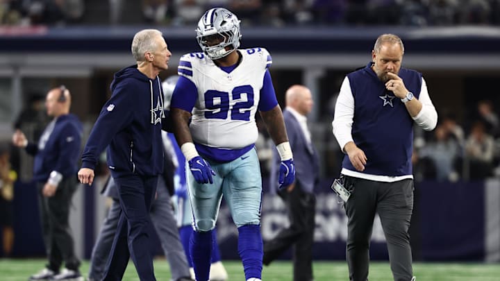 Dec 14, 2025; Arlington, Texas, USA; Dallas Cowboys defensive tackle Quinnen Williams (92) walks off the field with trainers after an injury during the second half against the Minnesota Vikings at AT&T Stadium. Mandatory Credit: Kevin Jairaj-Imagn Images