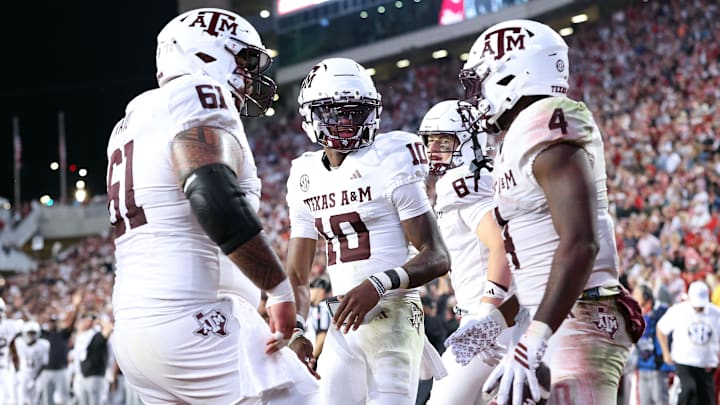 Oct 18, 2025; Fayetteville, Arkansas, USA; Texas A&M Aggies quarterback Marcel Reed (10) celebrates with running back Rueben Owens II (4) after Owner rushed for a touchdown in the fourth quarter against the Arkansas Razorbacks at Donald W. Reynolds Razorback Stadium. Mandatory Credit: Nelson Chenault-Imagn Images Oct 18, 2025; Fayetteville, Arkansas, USA; Texas A&M Aggies quarterback Marcel Reed (10) celebrates with running back Rueben Owens II (4) after Owner rushed for a touchdown in the fourth quarter against the Arkansas Razorbacks at Donald W. Reynolds Razorback Stadium. Mandatory Credit: Nelson Chenault-Imagn Images
