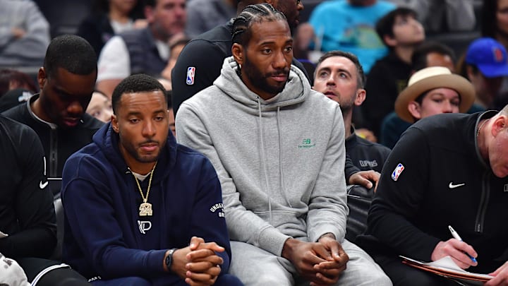 Mar 18, 2023; Los Angeles, California, USA; Los Angeles Clippers forward Kawhi Leonard (2) and forward Norman Powell (24) watch game action against the Orlando Magic during the first half at Crypto.com Arena. Mandatory Credit: Gary A. Vasquez-Imagn Images