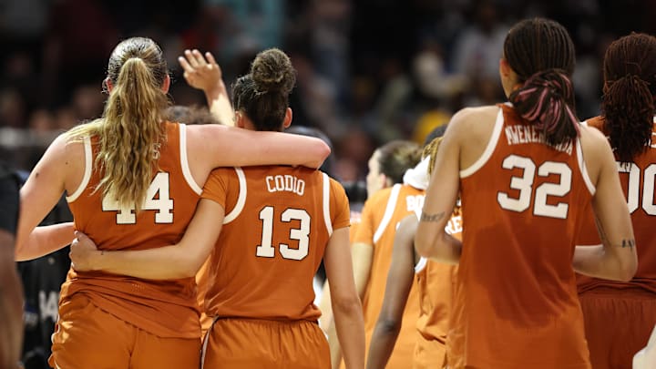 Apr 4, 2025; Tampa, FL, USA;  Texas Longhorns forward Taylor Jones (44) and Texas Longhorns guard Jordana Codio (13) walk off the court after losing to South Carolina Gamecocks during the semifinal of the women's 2025 NCAA tournament at Amalie Arena. Mandatory Credit: Nathan Ray Seebeck-Imagn Images