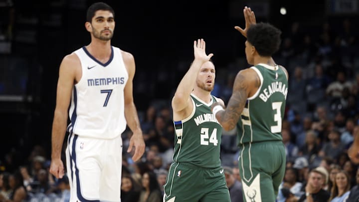 Oct 10, 2023; Memphis, Tennessee, USA; Milwaukee Bucks guard Pat Connaughton (24) reacts with forward MarJon Beauchamp (3) after a three point basket during the first half against the Memphis Grizzlies  at FedExForum. Mandatory Credit: Petre Thomas-Imagn Images