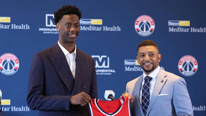 Jun 25, 2026; Washington, DC, USA; Washington Wizards first round draft pick and number one overall pick AJ Dybantsa (left) poses for a photo with his jersey and Wizards general manager Will Dawkins (right) during a press conference at InterContinental Hotel. Mandatory Credit: Amber Searls-Imagn Images