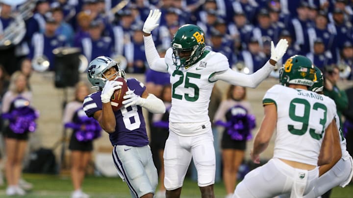 Nov 11, 2023; Manhattan, Kansas, USA; Kansas State Wildcats wide receiver Phillip Brooks (8) catches a punt as Baylor Bears cornerback Levar Thornton Jr. (25) tries to not interfere during the fourth quarter at Bill Snyder Family Football Stadium. 