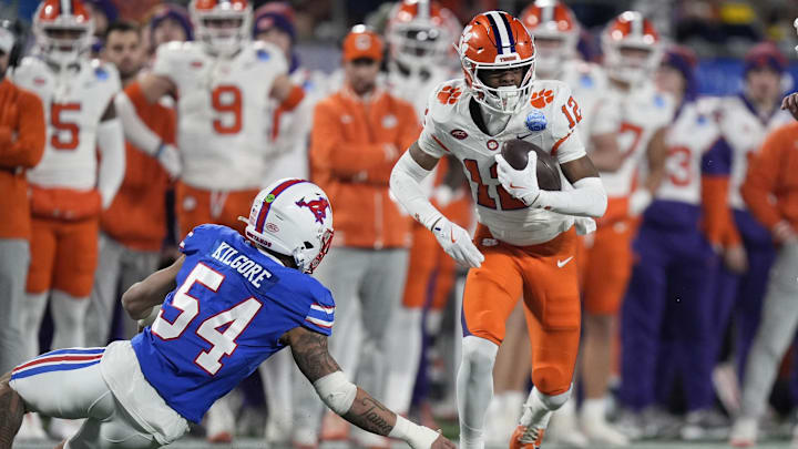 Dec 7, 2024; Charlotte, NC, USA; Clemson Tigers wide receiver Bryant Wesco Jr. (12) runs against Southern Methodist Mustangs linebacker Alexander Kilgore (54) during the second quarter in the 2024 ACC Championship game at Bank of America Stadium. 