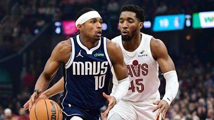 Feb 2, 2025; Cleveland, Ohio, USA; Dallas Mavericks guard Brandon Williams (10) drives to the basket against Cleveland Cavaliers guard Donovan Mitchell (45) during the first half at Rocket Mortgage FieldHouse. Mandatory Credit: Ken Blaze-Imagn Images