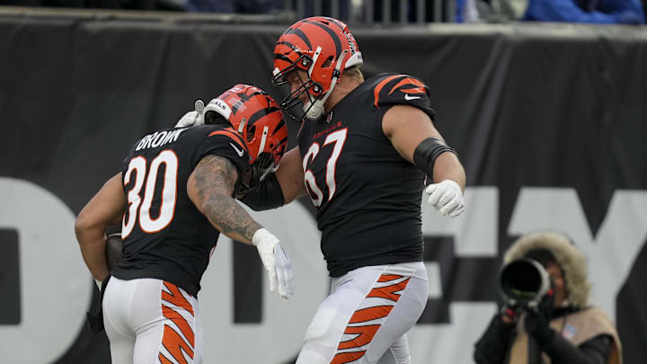 Dec 10, 2023; Cincinnati, Ohio, USA; Cincinnati Bengals running back Chase Brown (30) celebrates with Cincinnati Bengals guard Cordell Volson (67) after scoring a touchdown at Paycor Stadium. Mandatory Credit: Jenna Watson-Imagn Images
