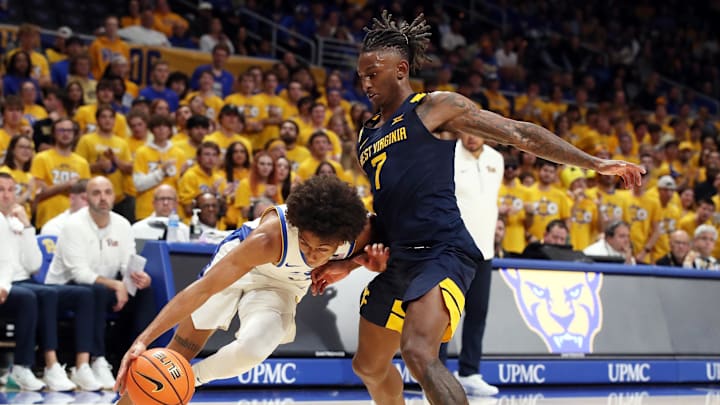 Nov 15, 2024; Pittsburgh, Pennsylvania, USA;  Pittsburgh Panthers guard Brandin Cummings (left) handles the ball as West Virginia Mountaineers guard Javon Small (7) defends during the second half at the Petersen Events Center. Mandatory Credit: Charles LeClaire-Imagn Images