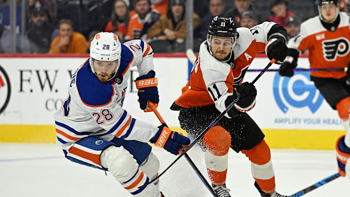 Nov 12, 2025; Philadelphia, Pennsylvania, USA; Edmonton Oilers center Jack Roslovic (28) and Philadelphia Flyers right wing Travis Konecny (11) battle at Xfinity Mobile Arena. Mandatory Credit: Eric Hartline-Imagn Images