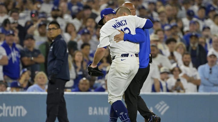 Jul 2, 2025; Los Angeles, California, USA; Los Angeles Dodgers third baseman Max Muncy (13) is helped off the field after he was injured on a play during the fifth inning against the Chicago White Sox at Dodger Stadium. Mandatory Credit: Jayne Kamin-Oncea-Imagn Images Jul 2, 2025; Los Angeles, California, USA; Los Angeles Dodgers third baseman Max Muncy (13) is helped off the field after he was injured on a play during the fifth inning against the Chicago White Sox at Dodger Stadium. Mandatory Credit: Jayne Kamin-Oncea-Imagn Images