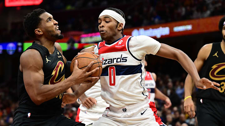 Dec 3, 2024; Cleveland, Ohio, USA; Cleveland Cavaliers guard Donovan Mitchell (45) drives to the basket against Washington Wizards guard Bilal Coulibaly (0) during the second half at Rocket Mortgage FieldHouse. Mandatory Credit: Ken Blaze-Imagn Images