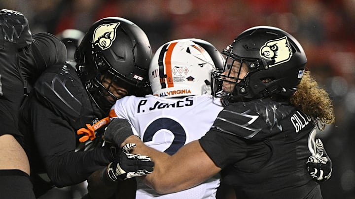 Nov 9, 2023; Louisville, Kentucky, USA; Louisville Cardinals defensive lineman Ashton Gillotte (9) tackles Virginia Cavaliers running back Perris Jones (2) during the second half at L&N Federal Credit Union Stadium. Louisville defeated Virginia 31-24. Mandatory Credit: Jamie Rhodes-USA TODAY Sports