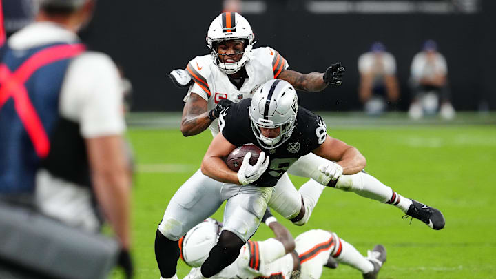 Sep 29, 2024; Paradise, Nevada, USA; Las Vegas Raiders tight end Brock Bowers (89) slips the tackle attempt of Cleveland Browns cornerback Denzel Ward (21) during the second quarter at Allegiant Stadium. Mandatory Credit: Stephen R. Sylvanie-Imagn Images