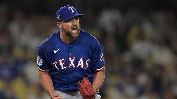 Jun 13, 2024; Los Angeles, California, USA;  Texas Rangers relief pitcher Kirby Yates (39) reacts after the final out of the ninth inning to earn a save against the Los Angeles Dodgers at Dodger Stadium. Mandatory Credit: Jayne Kamin-Oncea-USA TODAY Sports