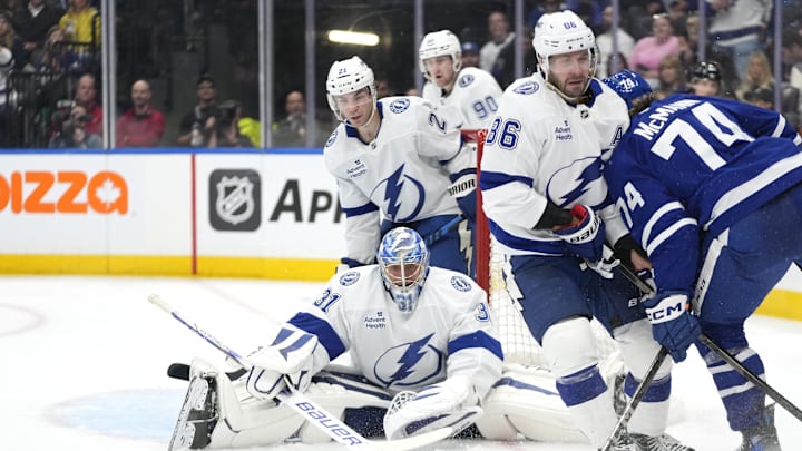 Oct 21, 2024; Toronto, Ontario, CAN; Tampa Bay Lightning forward Nikita Kucherov (86) blocks Toronto Maple Leafs forward Bobby McMann (74) from getting to a puck as Tampa Bay Lightning goaltender Jonas Johansson (31) and forward Brayden Point (21) defend the goal during the third period at Scotiabank Arena. Mandatory Credit: John E. Sokolowski-Imagn Images
