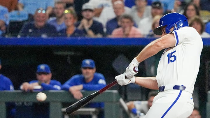 Sep 3, 2024; Kansas City, Missouri, USA; Kansas City Royals third baseman Paul DeJong (15) hits a one-run sacrifice against the Cleveland Guardians in the sixth inning at Kauffman Stadium. Mandatory Credit: Denny Medley-Imagn Images