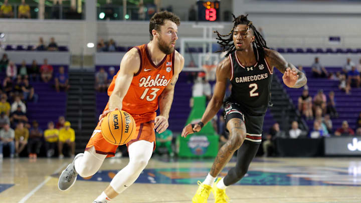 Nov 27, 2024; Fort Myers, Florida, USA; Virginia Tech Hokies forward Ben Burnham (13) drives to the hoop past South Carolina Gamecocks guard Zachary Davis (2) in the first half at Suncoast Credit Union Arena. Mandatory Credit: Nathan Ray Seebeck-Imagn Images