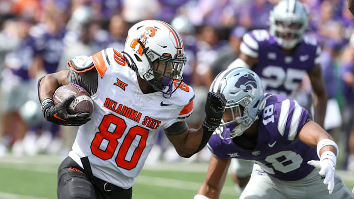 Sep 28, 2024; Manhattan, Kansas, USA; Oklahoma State Cowboys wide receiver Brennan Presley (80) is chased by Kansas State Wildcats safety Wesley Fair (18) during a punt return in the fourth quarter at Bill Snyder Family Football Stadium. Mandatory Credit: Scott Sewell-Imagn Images