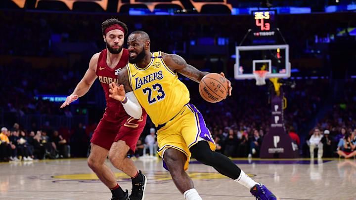 Dec 31, 2024; Los Angeles, California, USA; Los Angeles Lakers forward LeBron James (23) moves to the basket against Cleveland Cavaliers guard Max Strus (1) during the first half at Crypto.com Arena. Mandatory Credit: Gary A. Vasquez-Imagn Images