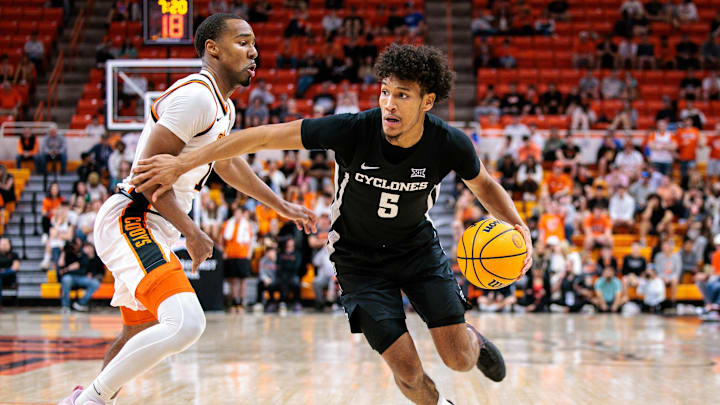 Feb 25, 2025; Stillwater, Oklahoma, USA; Iowa State Cyclones guard Curtis Jones (5) drives to the basket around Oklahoma State Cowboys guard Bryce Thompson (1) during the second half at Gallagher-Iba Arena. Mandatory Credit: William Purnell-Imagn Images Feb 25, 2025; Stillwater, Oklahoma, USA; Iowa State Cyclones guard Curtis Jones (5) drives to the basket around Oklahoma State Cowboys guard Bryce Thompson (1) during the second half at Gallagher-Iba Arena. Mandatory Credit: William Purnell-Imagn Images