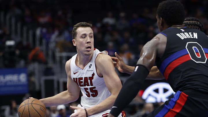 Nov 12, 2024; Detroit, Michigan, USA;  Miami Heat forward Duncan Robinson (55) dribbles defended by Detroit Pistons center Jalen Duren (0) in the first half at Little Caesars Arena. Mandatory Credit: Rick Osentoski-Imagn Images