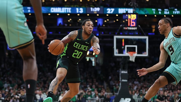 Apr 13, 2025; Boston, Massachusetts, USA; Boston Celtics guard JD Davison (20) dribbles down the court during the first half against the Charlotte Hornets at TD Garden. Mandatory Credit: Paul Rutherford-Imagn Images