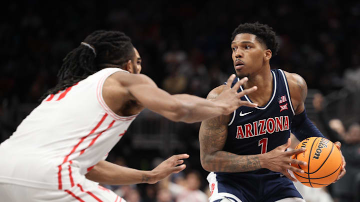 Mar 15, 2025; Kansas City, MO, USA; Arizona Wildcats guard Caleb Love (1) attempts to dribble the ball past Houston Cougars forward Joseph Tugler (11) during the second half for the Big 12 Conference Tournament Championship game at T-Mobile Center. Mandatory Credit: William Purnell-Imagn Images