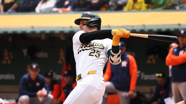 May 25, 2024; Oakland, California, USA; Oakland Athletics designated hitter Brent Rooker (25) hits an two-run RBI double against the Houston Astros during the first inning at Oakland-Alameda County Coliseum. Mandatory Credit: Kelley L Cox-USA TODAY Sports