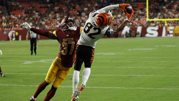 Aug 18, 2025; Landover, Maryland, USA; Cincinnati Bengals wide receiver Mitchell Tinsley (82) catches a touchdown pass as Washington Commanders cornerback Bobby Price (37) defends during the second quarter at Northwest Stadium. Mandatory Credit: Geoff Burke-Imagn Images