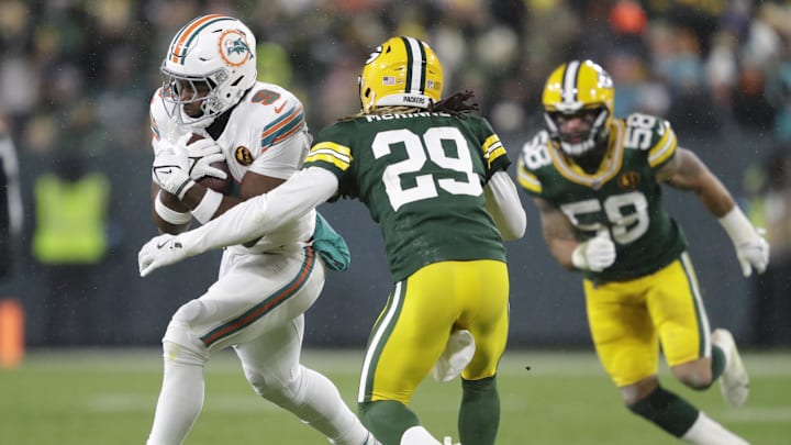 Miami Dolphins tight end Jonnu Smith (9) runs for a first down on a reception against Green Bay Packers safety Xavier McKinney (29)  during the second half at Lambeau Field.