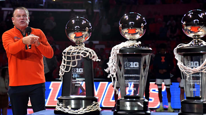 Nov 8, 2024; Champaign, Illinois, USA;  Illinois Fighting Illini head coach Brad Underwood displays the three consecutive Big 10 championship trophies before a game against the SIU Edwardsville Cougars at State Farm Center. Mandatory Credit: Ron Johnson-Imagn Images