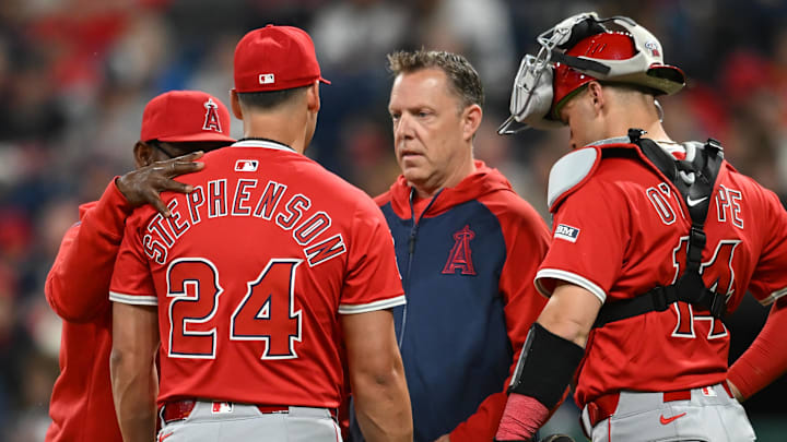 May 30, 2025; Cleveland, Ohio, USA; Los Angeles Angels relief pitcher Robert Stephenson (24) is looked at by a trainer after being injured during the seventh inning against the Cleveland Guardians at Progressive Field. Mandatory Credit: Ken Blaze-Imagn Images
