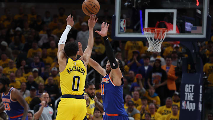 May 27, 2025; Indianapolis, Indiana, USA; Indiana Pacers guard Tyrese Haliburton (0) shoots a three point basket over New York Knicks guard Jalen Brunson (11) during the third quarter of game four of the eastern conference finals for the 2025 NBA Playoffs at Gainbridge Fieldhouse. Mandatory Credit: Trevor Ruszkowski-Imagn Images