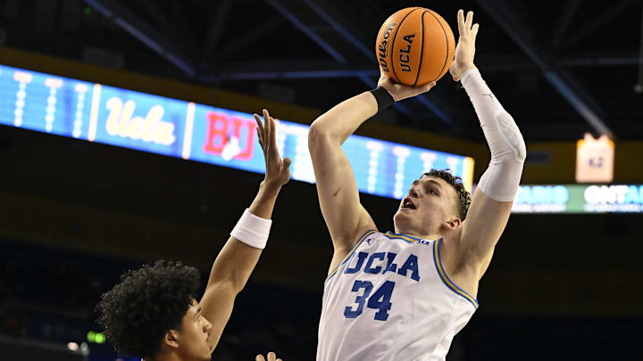 Nov 11, 2024; Los Angeles, California, USA; UCLA Bruins forward Tyler Bilodeau (34) shoots over Boston University Terriers forward Matai Baptiste (0) during the second half at Pauley Pavilion presented by Wescom. Mandatory Credit: Robert Hanashiro-Imagn Image