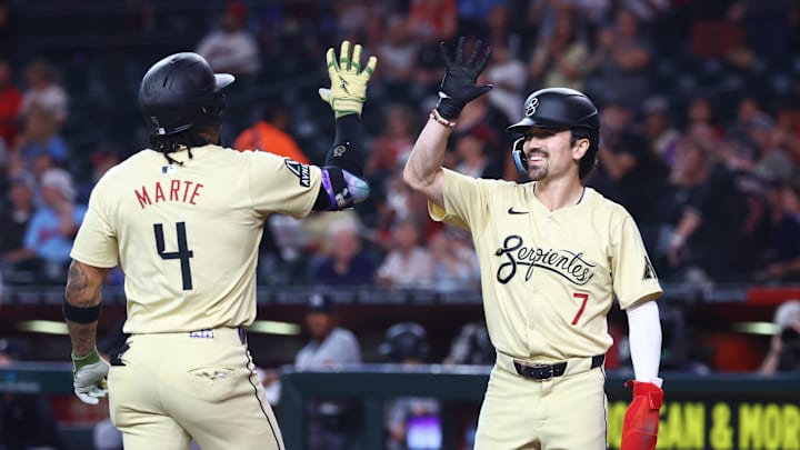 Jun 25, 2024; Phoenix, Arizona, USA; Arizona Diamondbacks infielder Ketel Marte (4) celebrates with teammate Corbin Carroll (7) after hitting a two run home run in the first inning against the Minnesota Twins at Chase Field. Mandatory Credit: Mark J. Rebilas-Imagn Images
