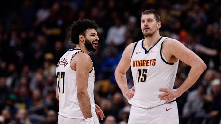 Feb 10, 2025; Denver, Colorado, USA; Denver Nuggets guard Jamal Murray (27) reacts after a call as center Nikola Jokic (15) looks on in the third quarter against the Portland Trail Blazers at Ball Arena. Mandatory Credit: Isaiah J. Downing-Imagn Images