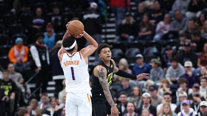 Nov 12, 2024; Salt Lake City, Utah, USA; Phoenix Suns guard Devin Booker (1) takes a three point shot over Utah Jazz guard Keyonte George (3) during the fourth quarter at Delta Center. Mandatory Credit: Rob Gray-Imagn Images