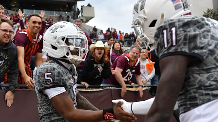 Nov 22, 2025; Blacksburg, Virginia, USA;  Virginia Tech Hokies quarterback William Watson III (5) and Virginia Tech Hokies wide receiver Isaiah Spencer (11) celebrate a touchdown by Watson during the fourth quarter Lane Stadium. Mandatory Credit: Brian Bishop-Imagn Images