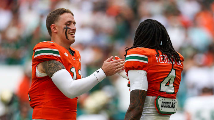 Sep 13, 2025; Miami Gardens, Florida, USA; Miami Hurricanes quarterback Carson Beck (11) greets running back Mark Fletcher Jr. (4) before a game against the South Florida Bulls at Hard Rock Stadium. Mandatory Credit: Nathan Ray Seebeck-Imagn Images Sep 13, 2025; Miami Gardens, Florida, USA; Miami Hurricanes quarterback Carson Beck (11) greets running back Mark Fletcher Jr. (4) before a game against the South Florida Bulls at Hard Rock Stadium. Mandatory Credit: Nathan Ray Seebeck-Imagn Images