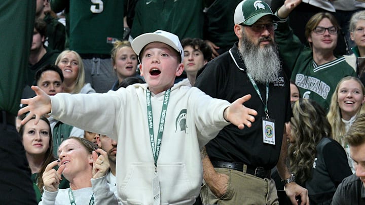 Nov 21, 2025; East Lansing, Michigan, USA;  A young Spartan fan voices his approval of play against the Detroit Mercy Titans during the second half at Jack Breslin Student Events Center. Mandatory Credit: Dale Young-Imagn Images