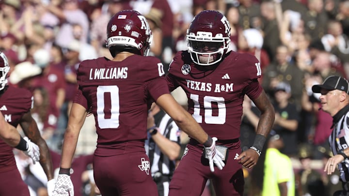 Nov 15, 2025; College Station, Texas, USA; Texas A&M Aggies quarterback Marcel Reed (10) celebrates with wide receiver Izaiah Williams (0) after an Aggies touchdown during the third quarter against the South Carolina Gamecocks at Kyle Field. Mandatory Credit: Troy Taormina-Imagn Images