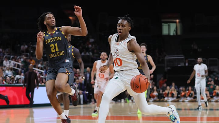 Mar 6, 2024; Coral Gables, Florida, USA; Miami Hurricanes guard Paul Djobet (10) drives to the basket against Boston College Eagles forward Devin McGlockton (21) during the second half at Watsco Center. Mar 6, 2024; Coral Gables, Florida, USA; Miami Hurricanes guard Paul Djobet (10) drives to the basket against Boston College Eagles forward Devin McGlockton (21) during the second half at Watsco Center.
