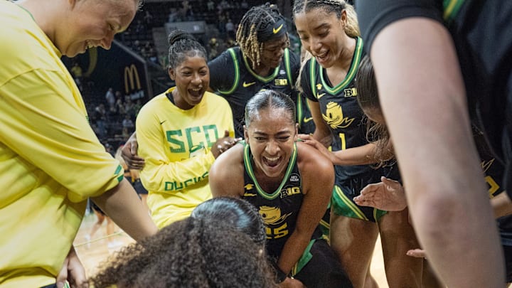Oregon’s Deja Kelly, center, celebrates with teammate after the Ducks upset Baylor game at Matthew Knight Arena in Eugene.