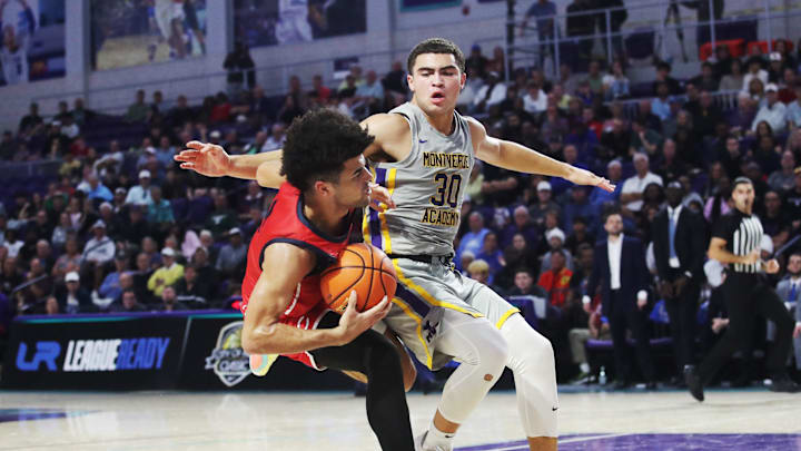 Cayden Boozer of the Miami Columbus High School basketball team drives to the basket during the championship game against Montverde at the City of Palms Classic at Suncoast Credit Union Arena in Fort Myers on Monday, Dec. 23, 2024. He is defended by Dante Allen of Montverde Academy. Miami Columbus won.