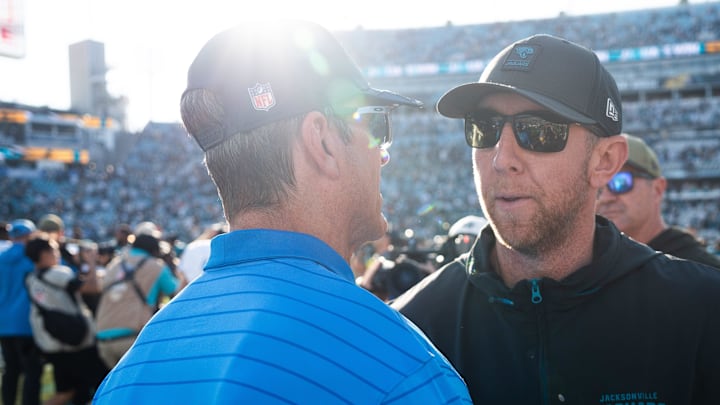 Los Angeles Chargers head coach Jim Harbaugh, left, meets Jacksonville Jaguars head coach Liam Coen after the game in an NFL football game at EverBank Stadium, Sunday, November 16, 2025, in Jacksonville, Fla. The Jaguars defeated the Charger 35-6. [Doug Engle/Florida Times-Union]