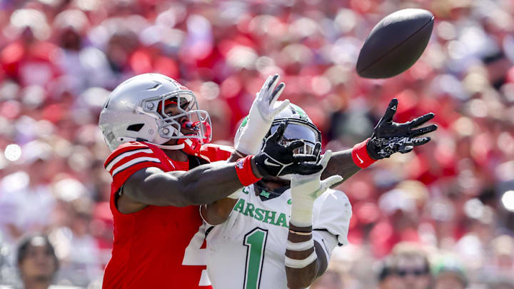 Sep 21, 2024; Columbus, Ohio, USA; Ohio State Buckeyes wide receiver Jeremiah Smith (4) goes for the ball with Marshall Thundering Herd defensive back Josh Moten (1) during the first quarter at Ohio Stadium. Mandatory Credit: Joseph Maiorana-Imagn Images