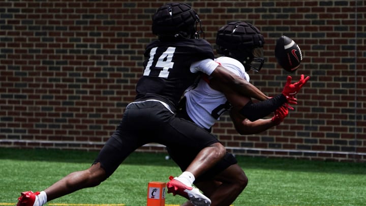 Cincinnati Bearcats defensive back Zay “Gravy” Johnson tackles wide receiver Elijah Jones (80) during a scrimmage, Saturday, Aug. 10, 2024, at Nippert Stadium in Cincinnati.