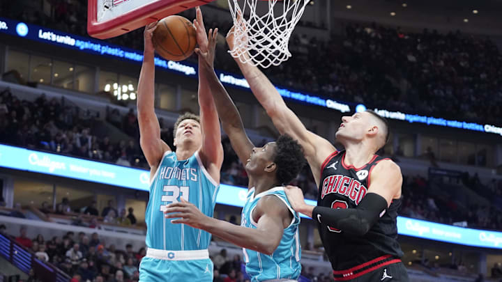 Jan 17, 2025; Chicago, Illinois, USA; Charlotte Hornets forward Tidjane Salaun (31) grabs rebound against Chicago Bulls center Nikola Vucevic (9) during the first quarter at United Center. Mandatory Credit: David Banks-Imagn Images Jan 17, 2025; Chicago, Illinois, USA; Charlotte Hornets forward Tidjane Salaun (31) grabs rebound against Chicago Bulls center Nikola Vucevic (9) during the first quarter at United Center. Mandatory Credit: David Banks-Imagn Images