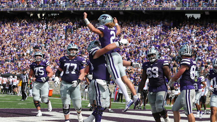 Sep 28, 2024; Manhattan, Kansas, USA; Kansas State Wildcats quarterback Avery Johnson (2) leaps into the arms of offensive lineman Hadley Panzer (54) after scoring a touchdown against the Oklahoma State Cowboys in the fourth quarter at Bill Snyder Family Football Stadium. Mandatory Credit: Scott Sewell-Imagn Images Sep 28, 2024; Manhattan, Kansas, USA; Kansas State Wildcats quarterback Avery Johnson (2) leaps into the arms of offensive lineman Hadley Panzer (54) after scoring a touchdown against the Oklahoma State Cowboys in the fourth quarter at Bill Snyder Family Football Stadium. Mandatory Credit: Scott Sewell-Imagn Images