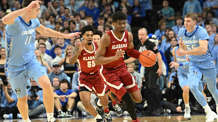 Dec 16, 2023; Omaha, Nebraska, USA; Alabama Crimson Tide forward Mohamed Wague (11) drives up the